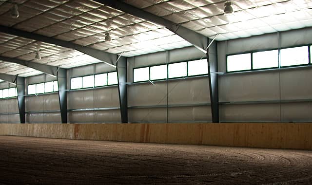 Riding arena interior with ceiling insulation