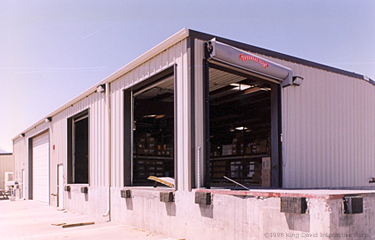 A warehouse building with multiple loading docks for trucks